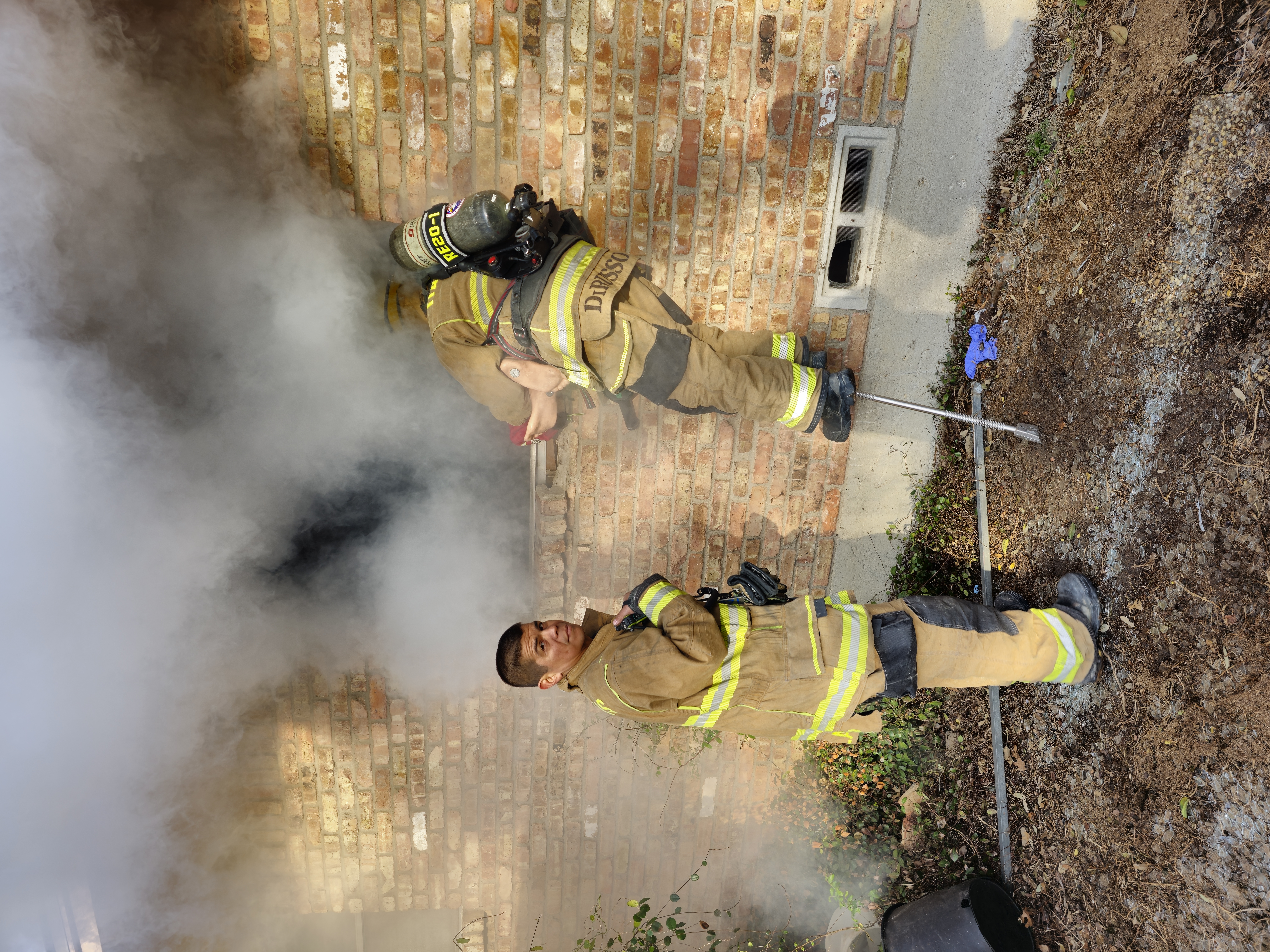 Two Dallas firefighters working a smoke-filled structure