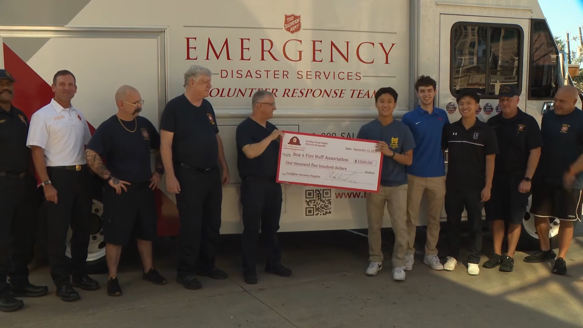 Fireline Fund Dallas presenting a $1,500 check to the Box 4 Fire Buff Association with Dallas firefighters